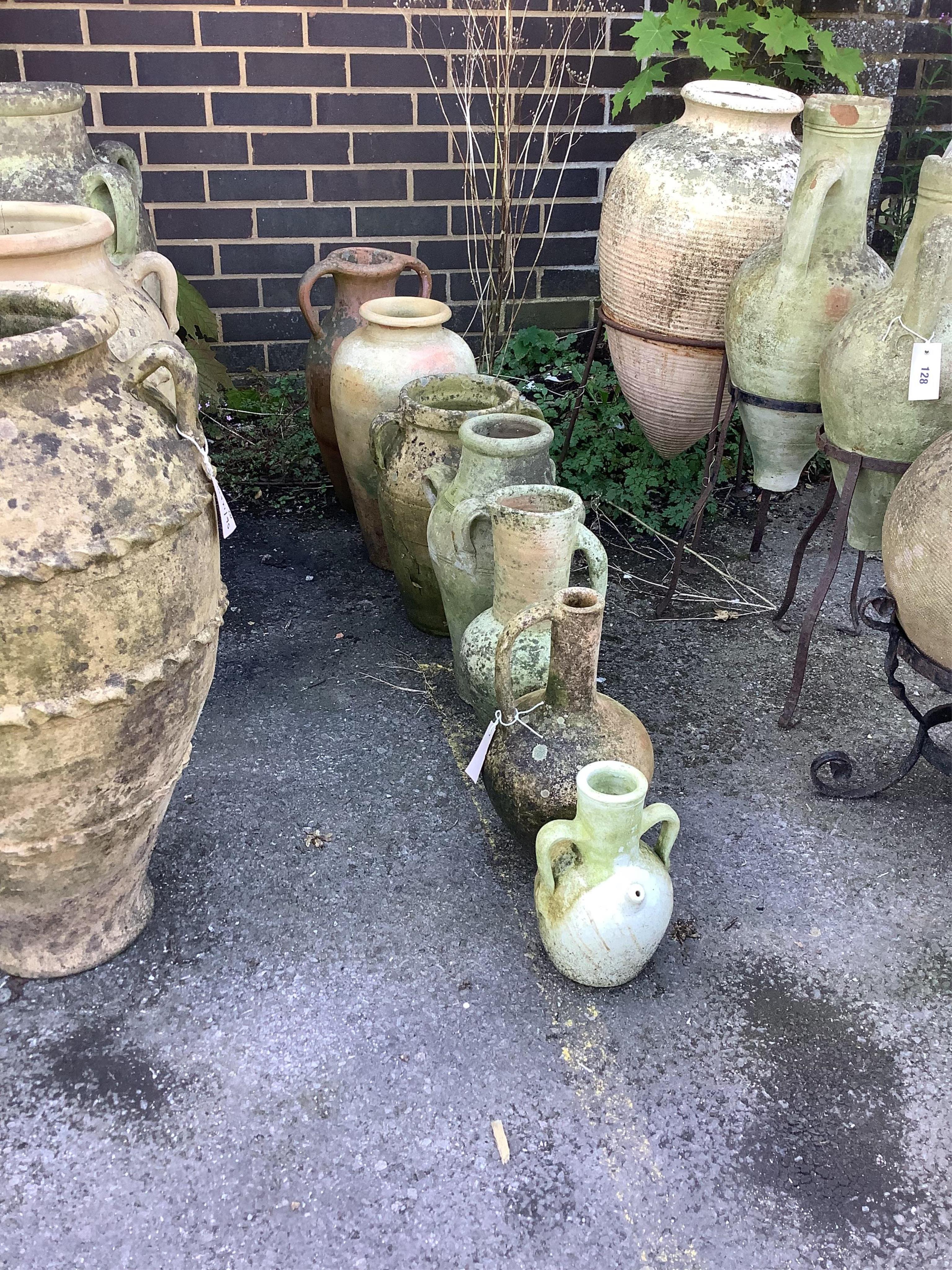 Seven terracotta and earthenware jars and urns, largest height 48cm. Condition - fair